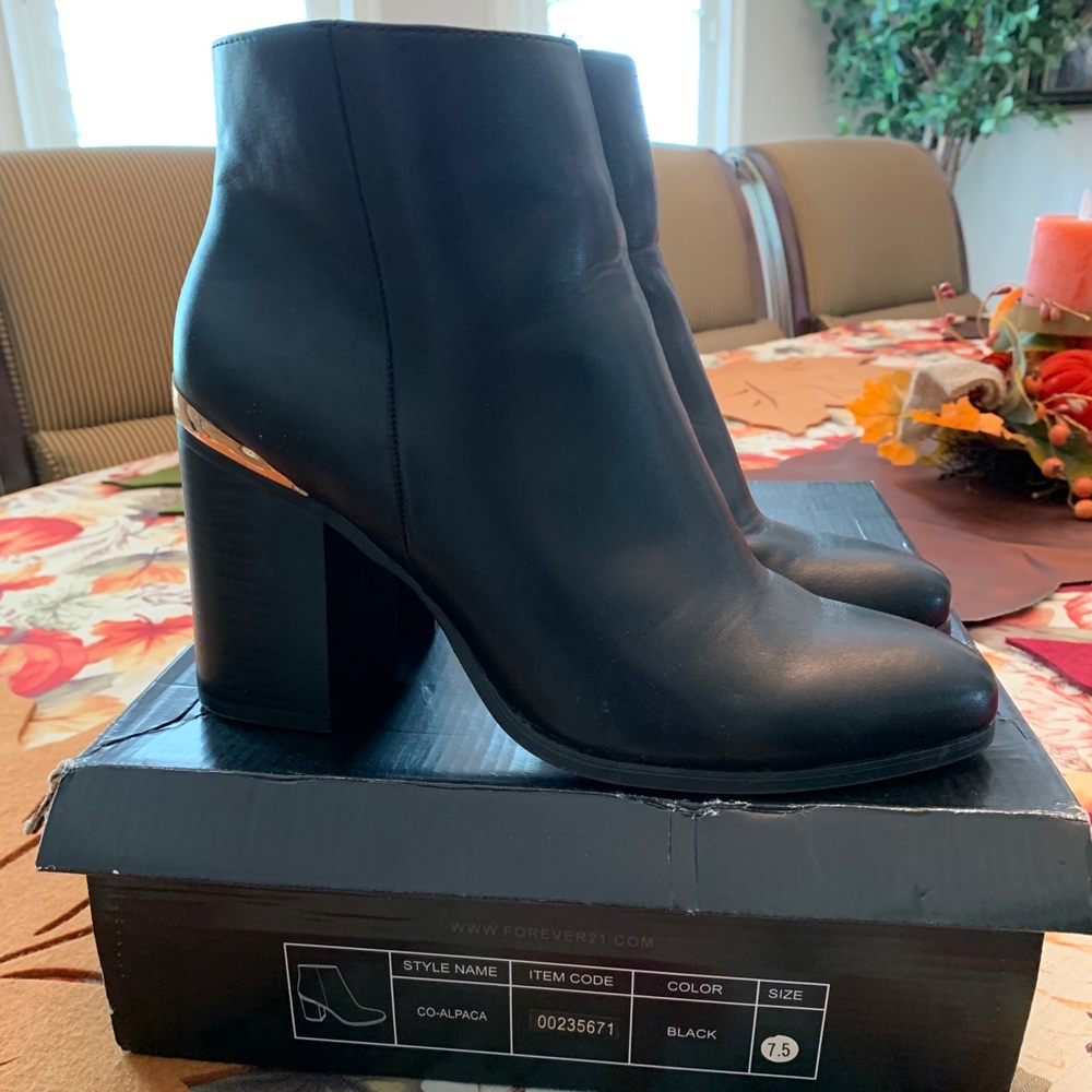 Black ankle booties with gold accent on heel